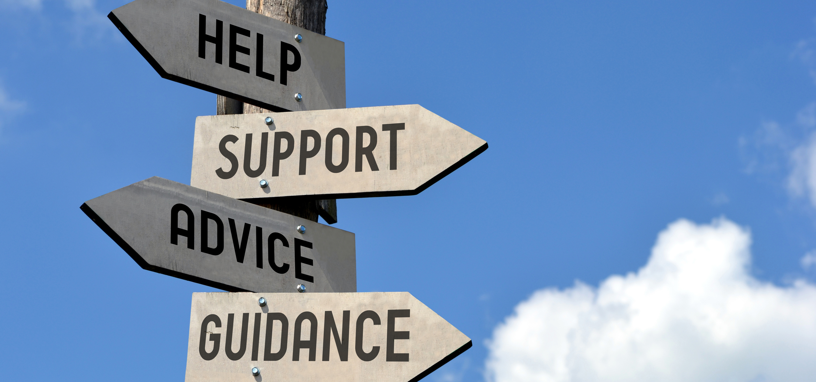 Sign post pointing to help, support, advice, and guidance, with blue skies in the background.